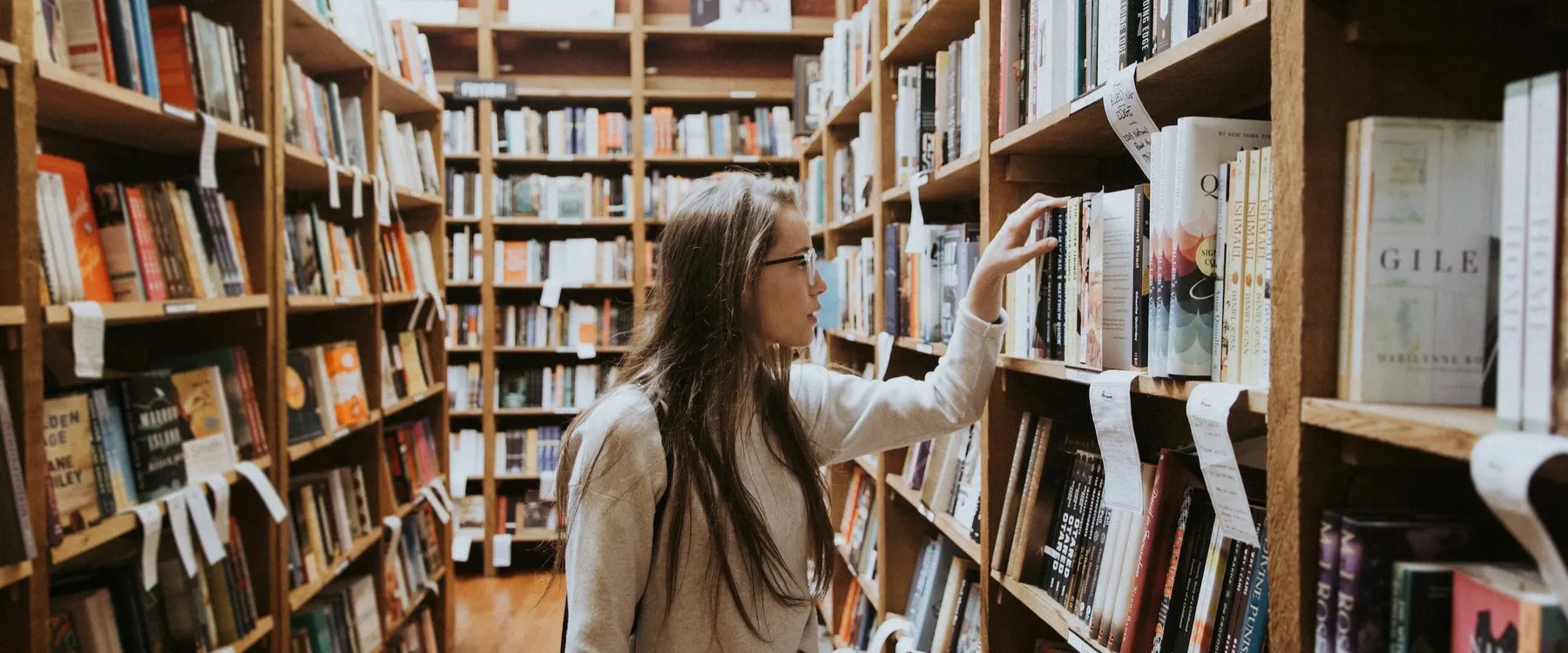 A student browsing books in a library